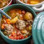 albondigas in teal bowls with a spoon