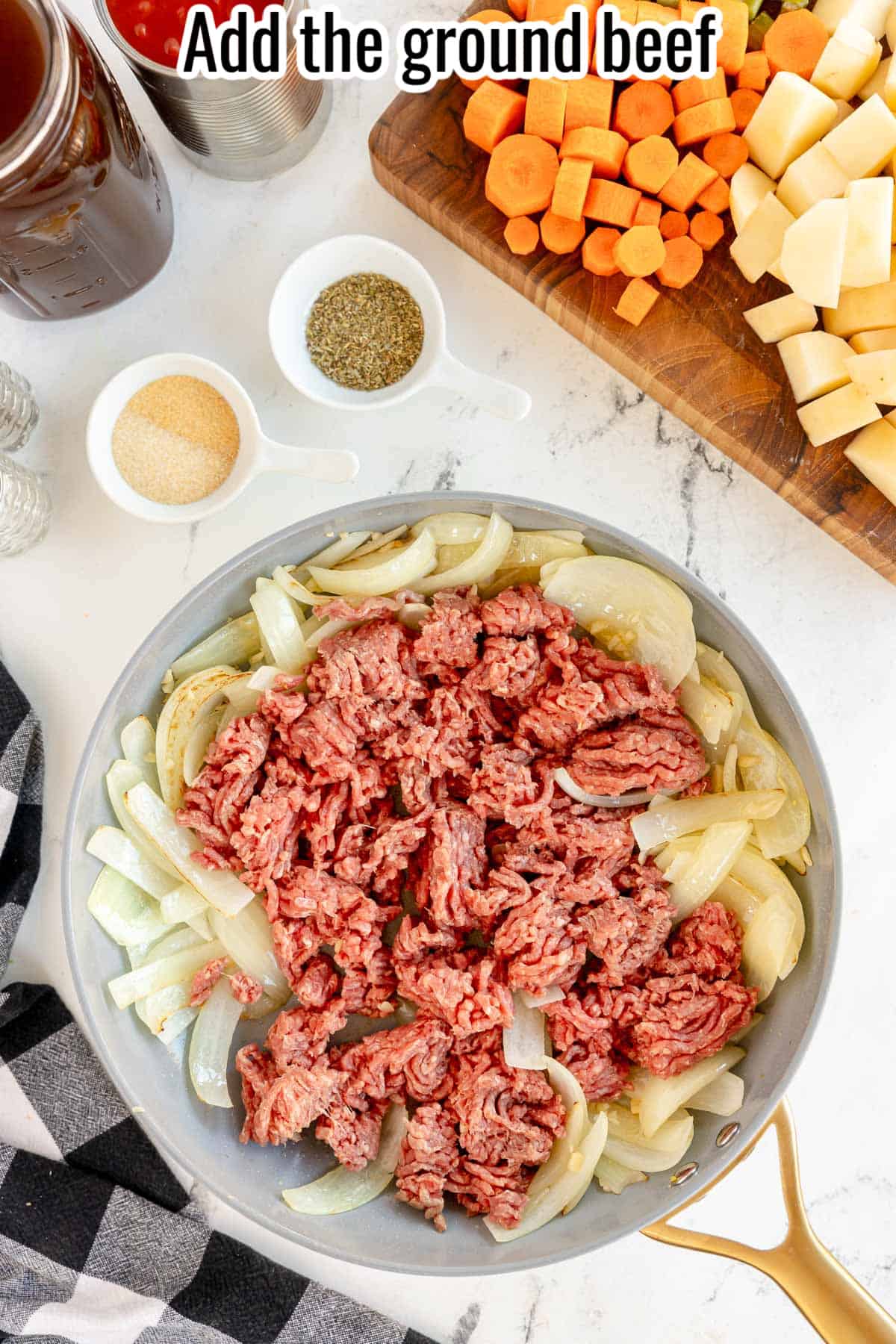 uncooked beef and onions in a skillet.