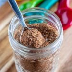 taco seasoning in a glass jar with a spoon