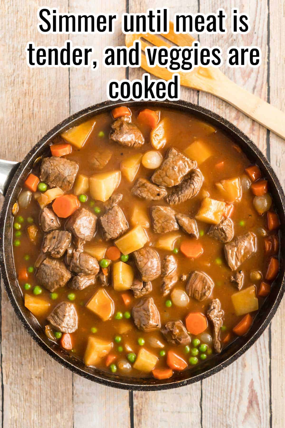 A black skillet with stove top beef stew in it.