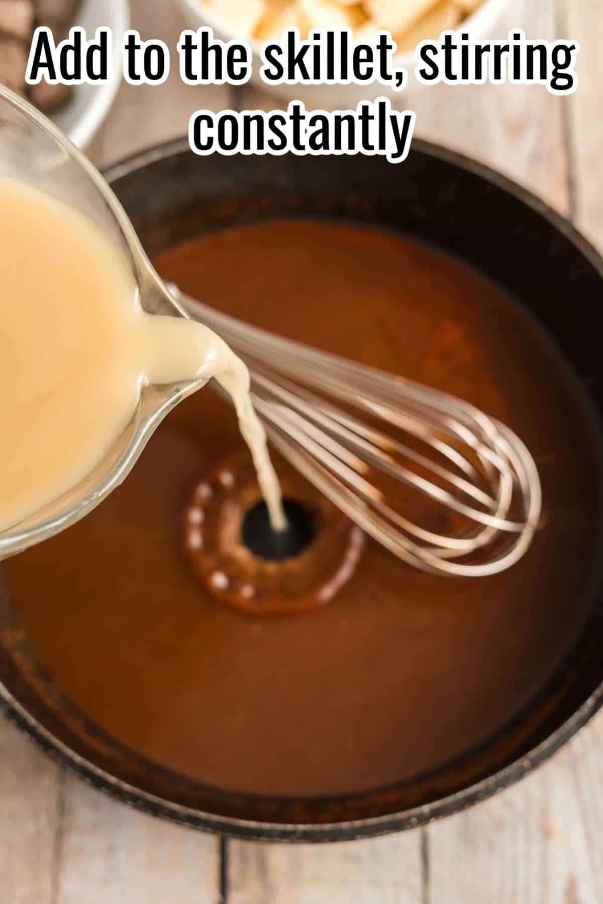 A skillet with liquid being poured in, and a whisk.