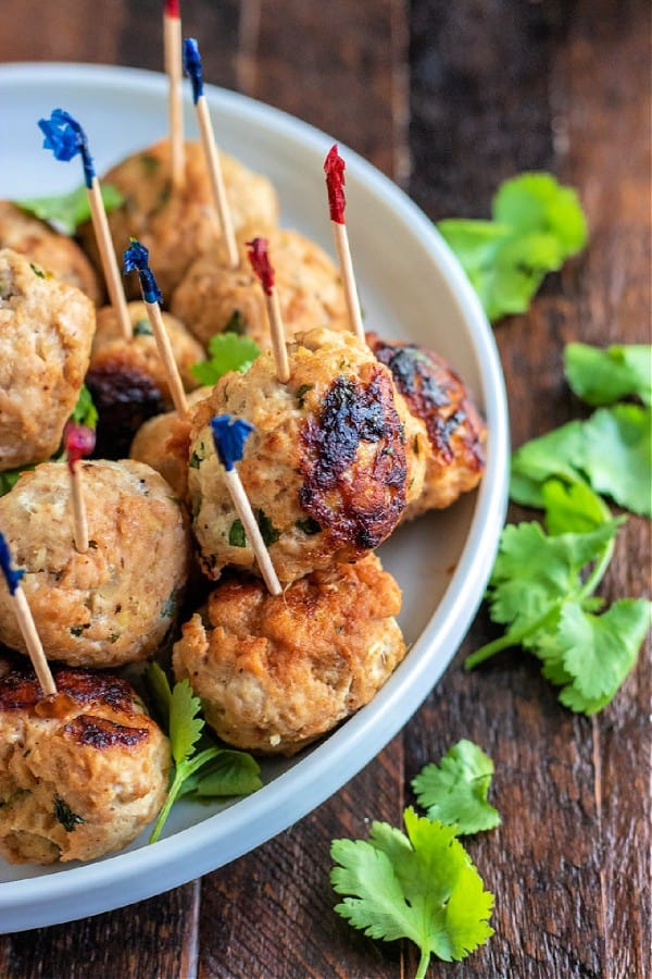 chicken meatballs on a plate with cilantro..