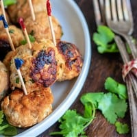 chicken meatballs on a plate with forks.