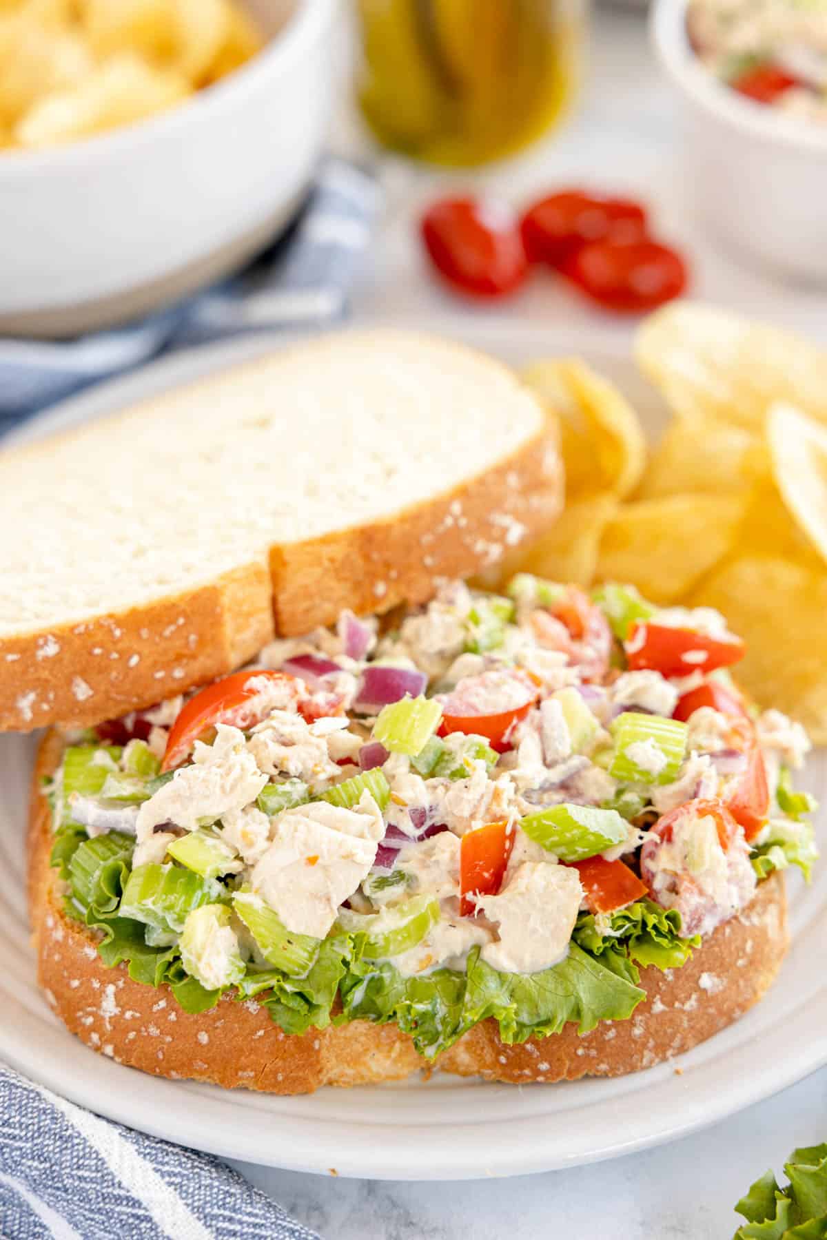 tuna salad sandwich on white bread, on a plate.