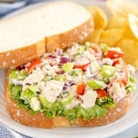 tuna salad sandwich on white bread, on a plate.
