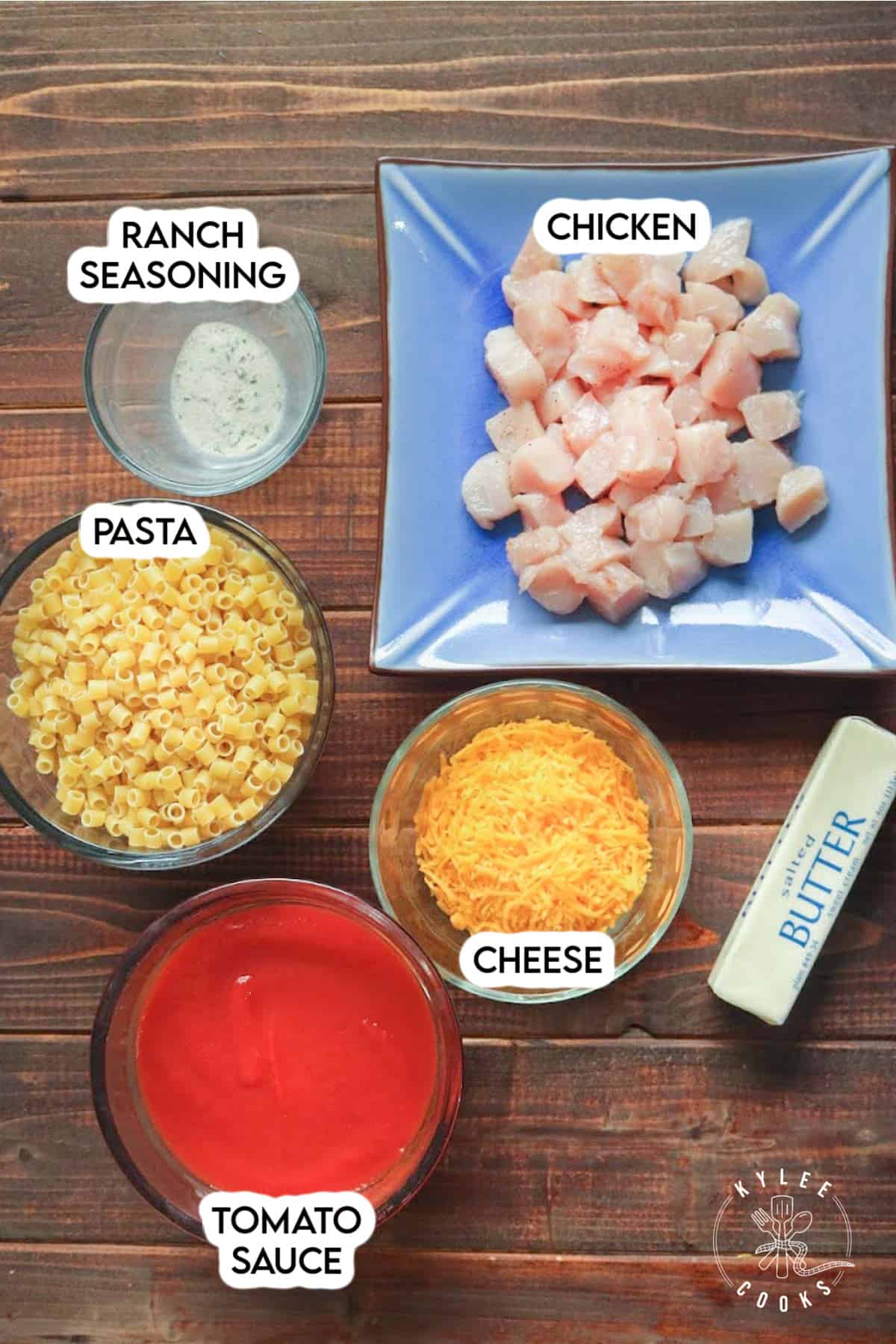 Ingredients to make chicken tomato pasta laid out and labeled.