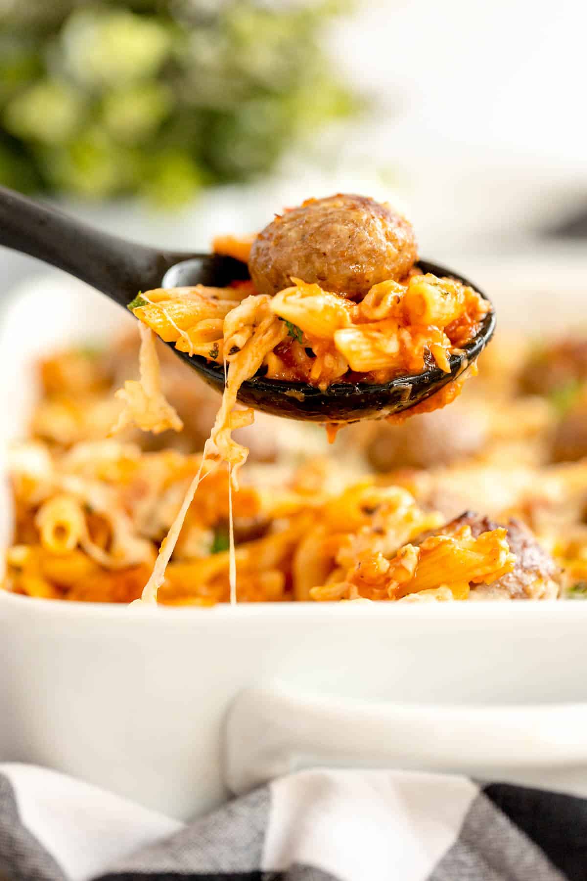 meatball casserole in a white bowl with a fork.