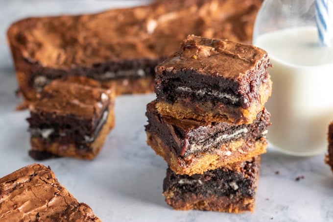 slutty brownies stacked with a milk bottle beside