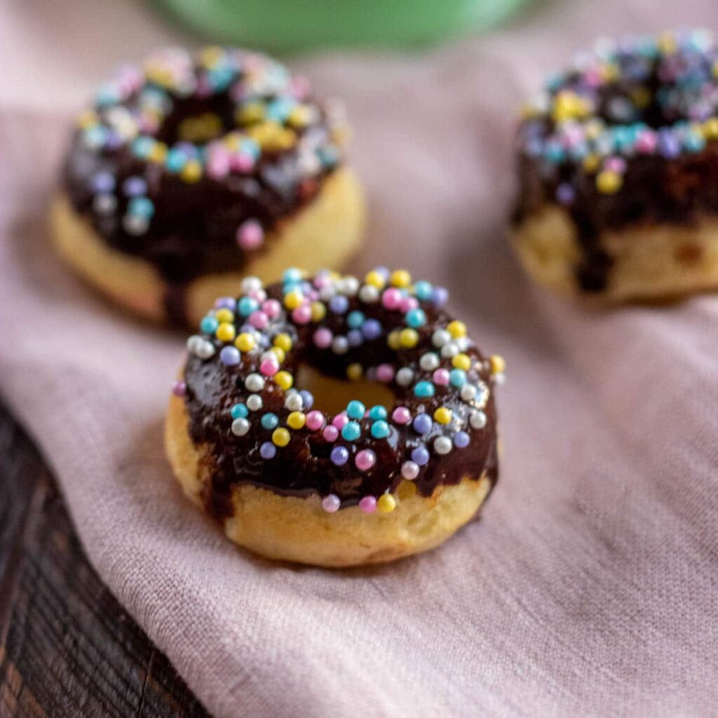 A donut with chocolate frosting and sprinkles