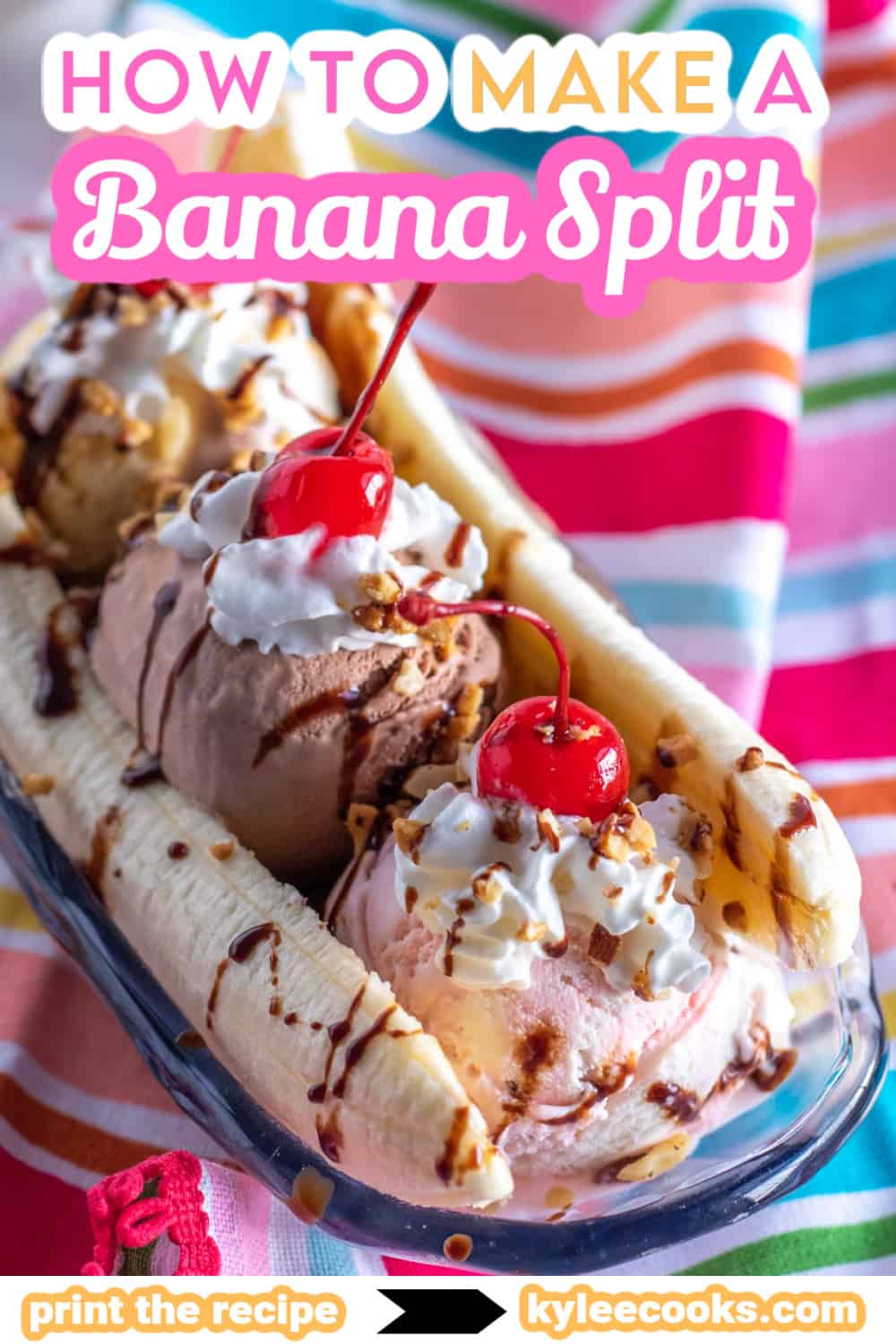 a banana split in a glass bowl with a bright colored napkin.