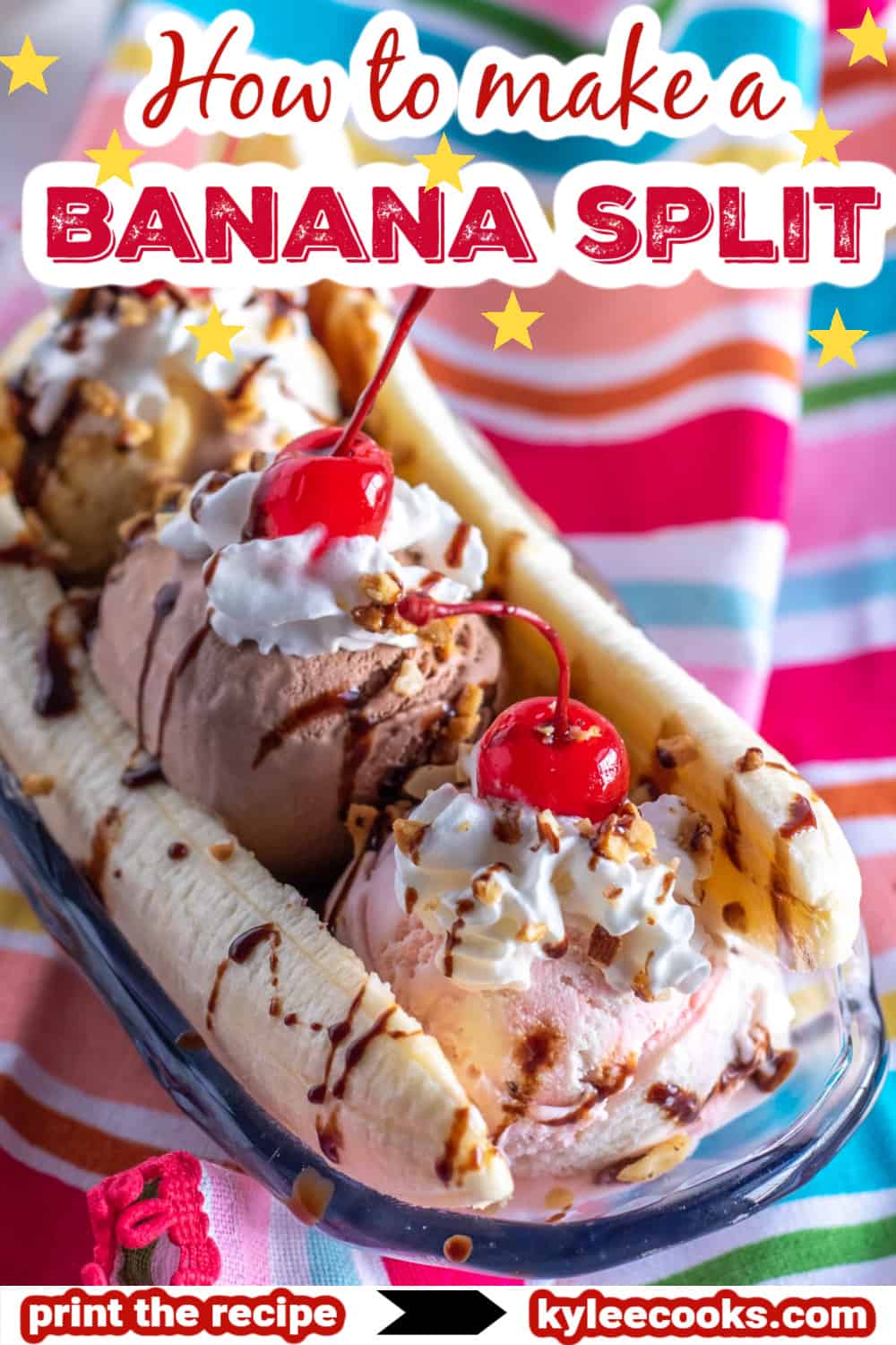 a banana split in a glass bowl with a bright colored napkin.