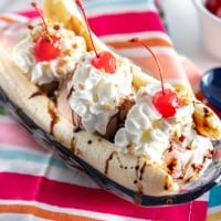 banana split on a brightly colored napkin with spoons
