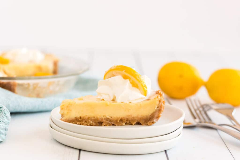 lemon pie on a white plate with a fork