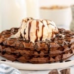 brownie waffles on a plate with a scoop of vanilla icecream.