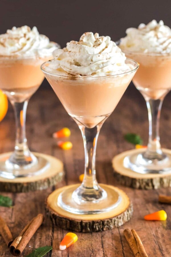 pumpkin drink in a martini glass with whipped cream