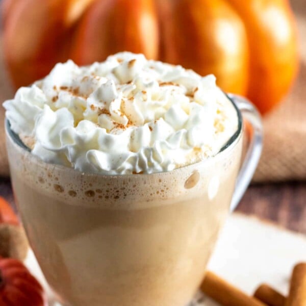 pumpkin spice latte with whipped cream in a clear mug