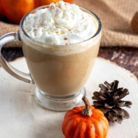 pumpkin spice latte in a glass cup with whipped cream