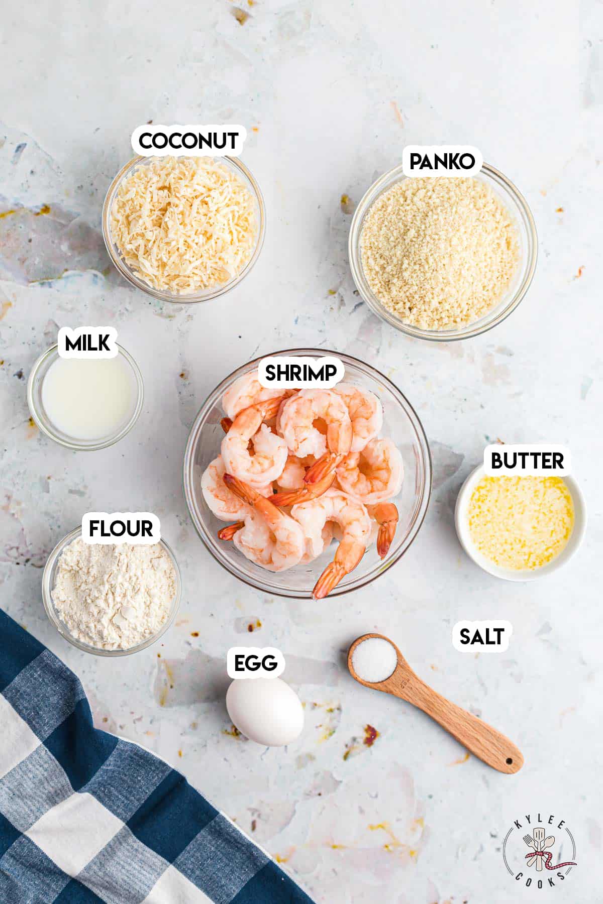 ingredients to make baked coconut shrimp laid out and labeled