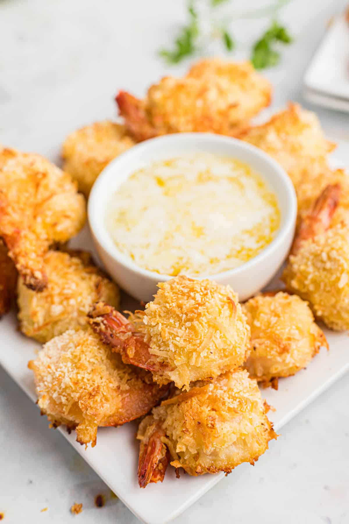 coconut shrimp on a platter with dipping sauce