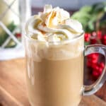 eggnog latte in a glass mug with whipped cream
