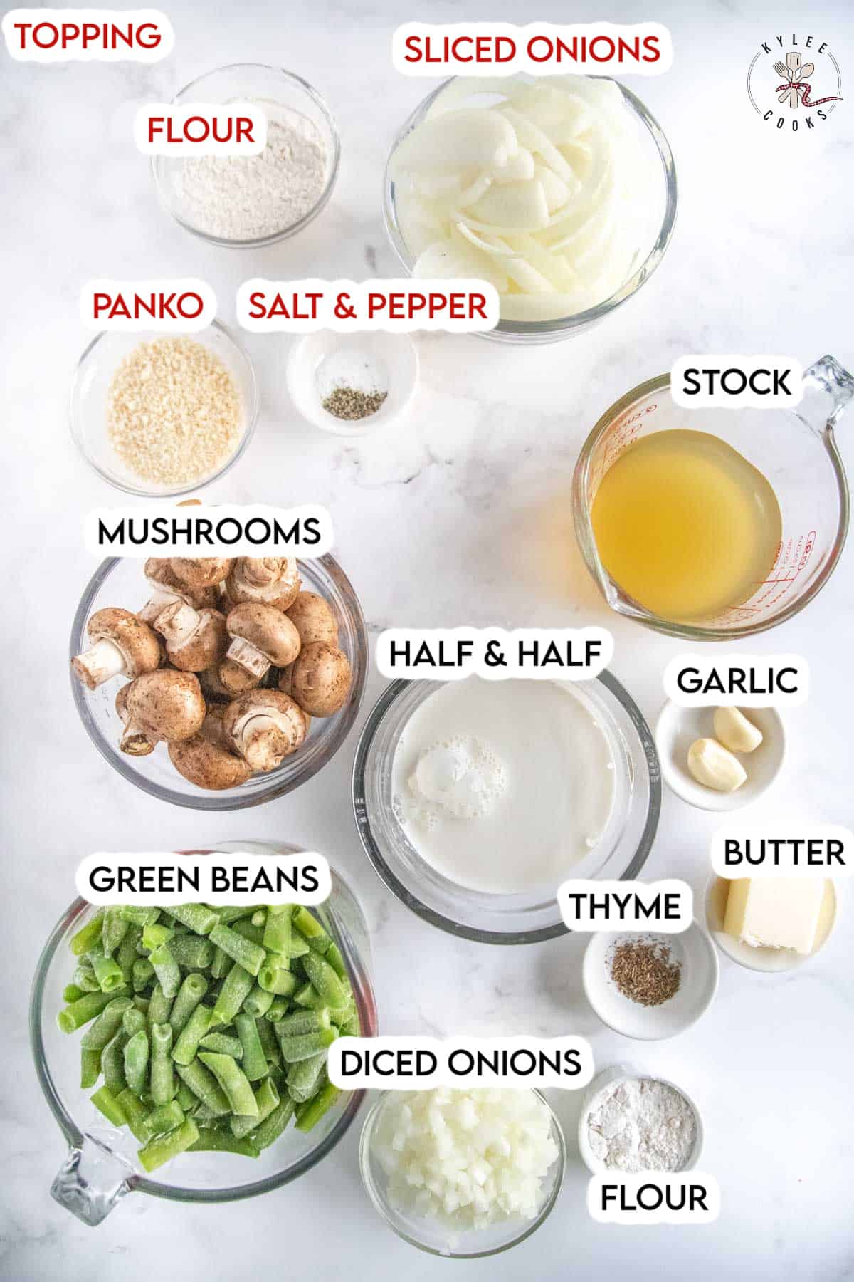 ingredients to make green bean casserole laid out on a white board.