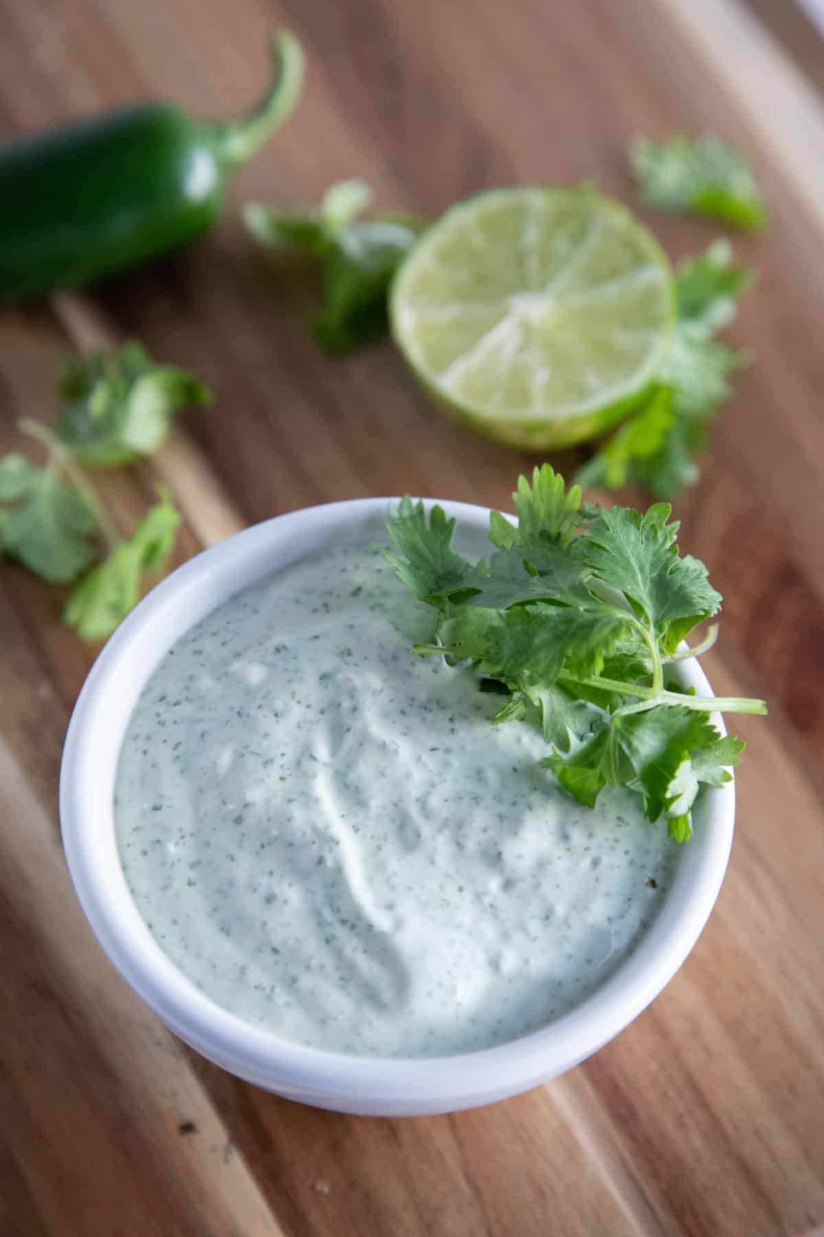 jalapeno ranch in a bowl with cilantro and lime.