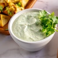 jalapeno ranch dip in a bowl with fried appetizers for dipping.