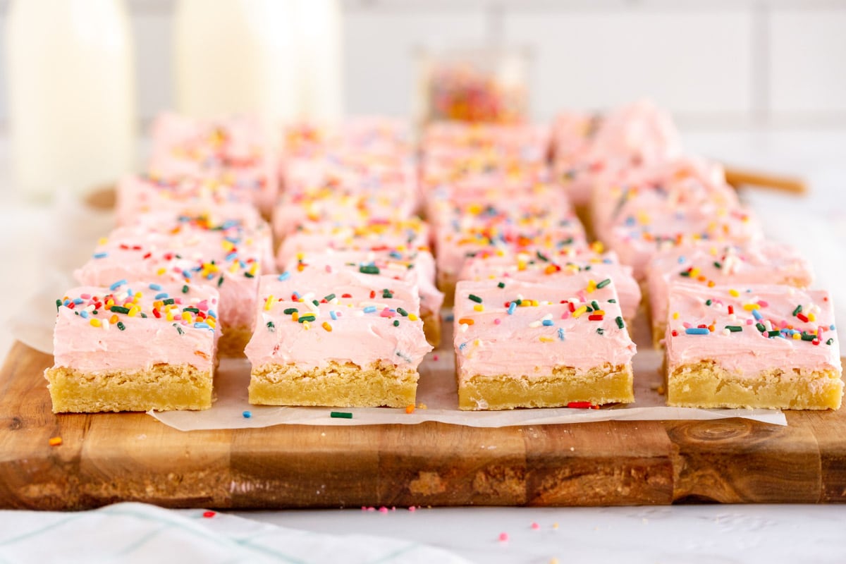 sugar cookie bars on a wooden board