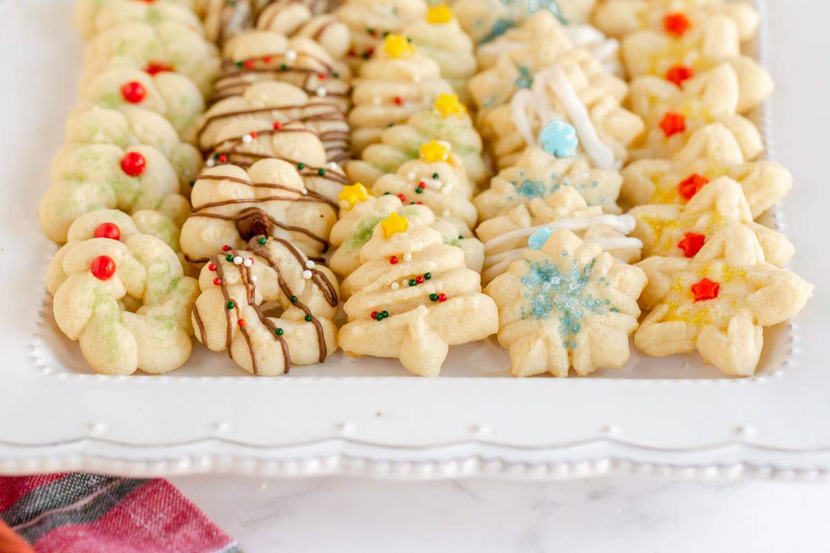 Christmas Spritz Cookies on a white fluted plate