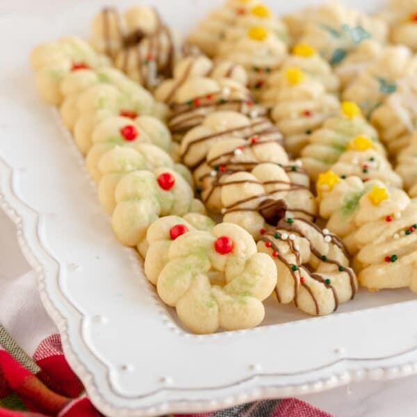square image of spritz cookies on a white platter