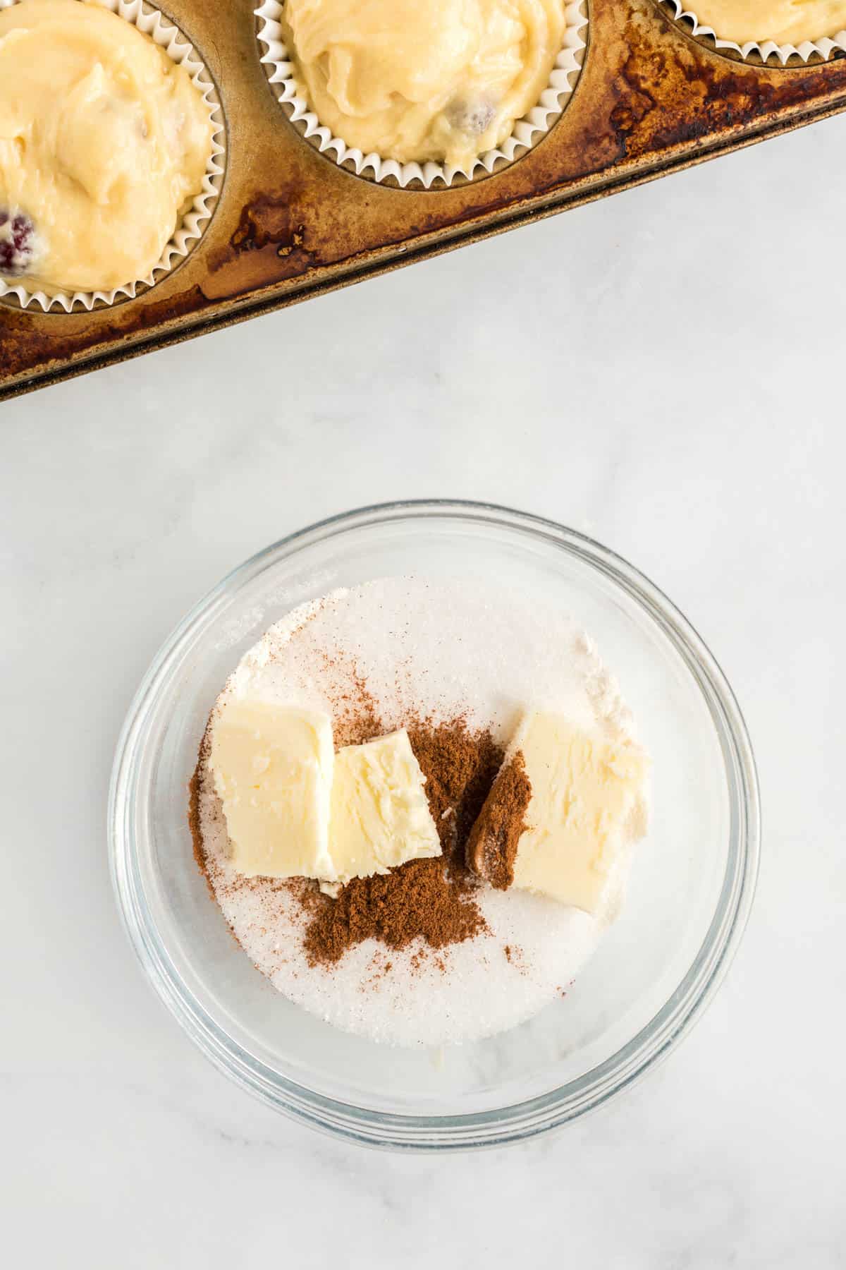 glass bowl with flour, cinnamon and butter.