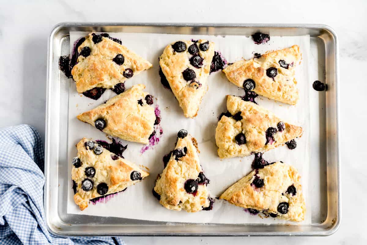 Blueberry scones on a baking rack with a blue napkin