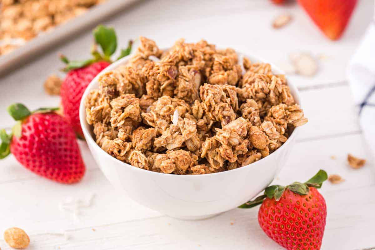 peanut butter granola in a bowl with strawberries