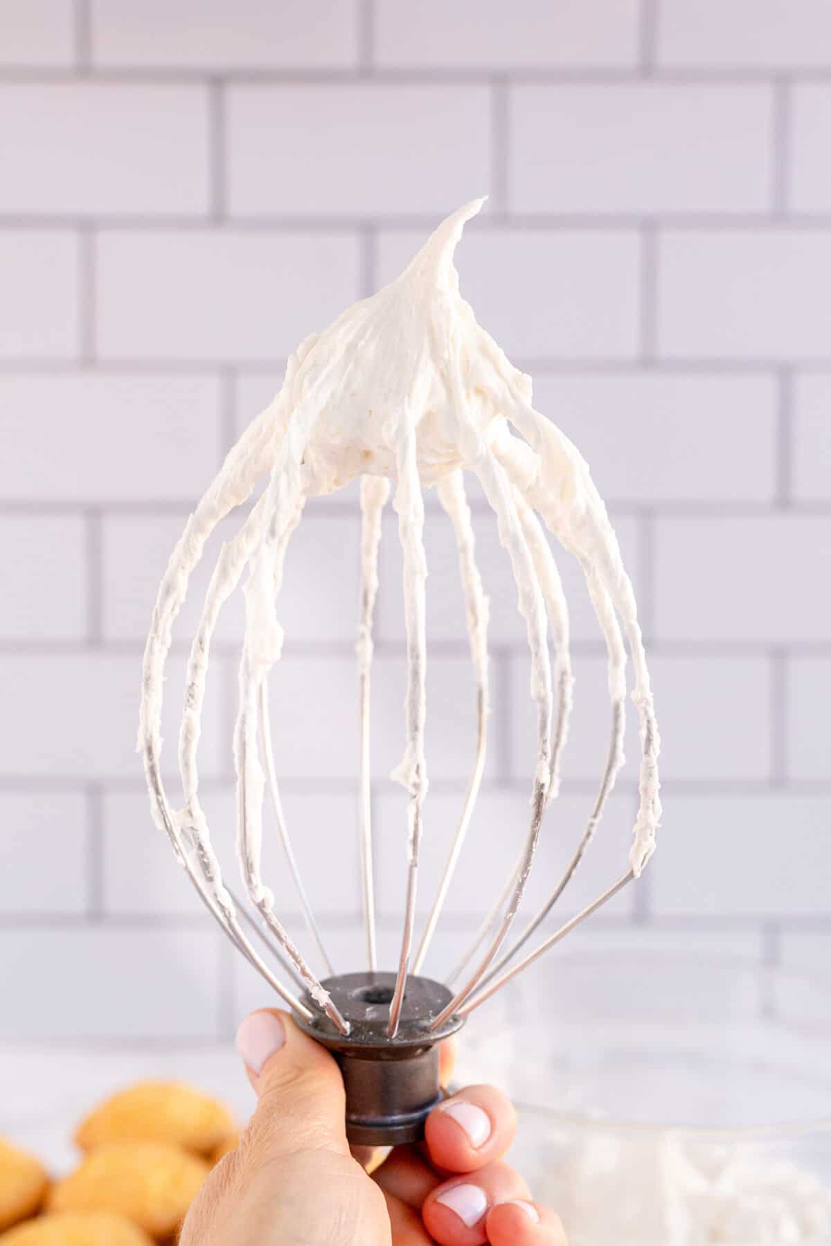 vanilla frosting on a wire whisk 