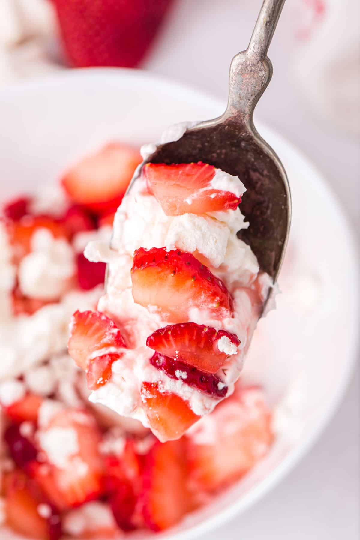 strawberries and cream on a spoon