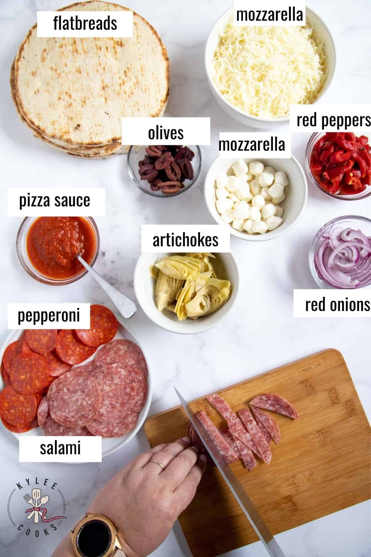 ingredients to make flatbread pizzas laid out and labeled