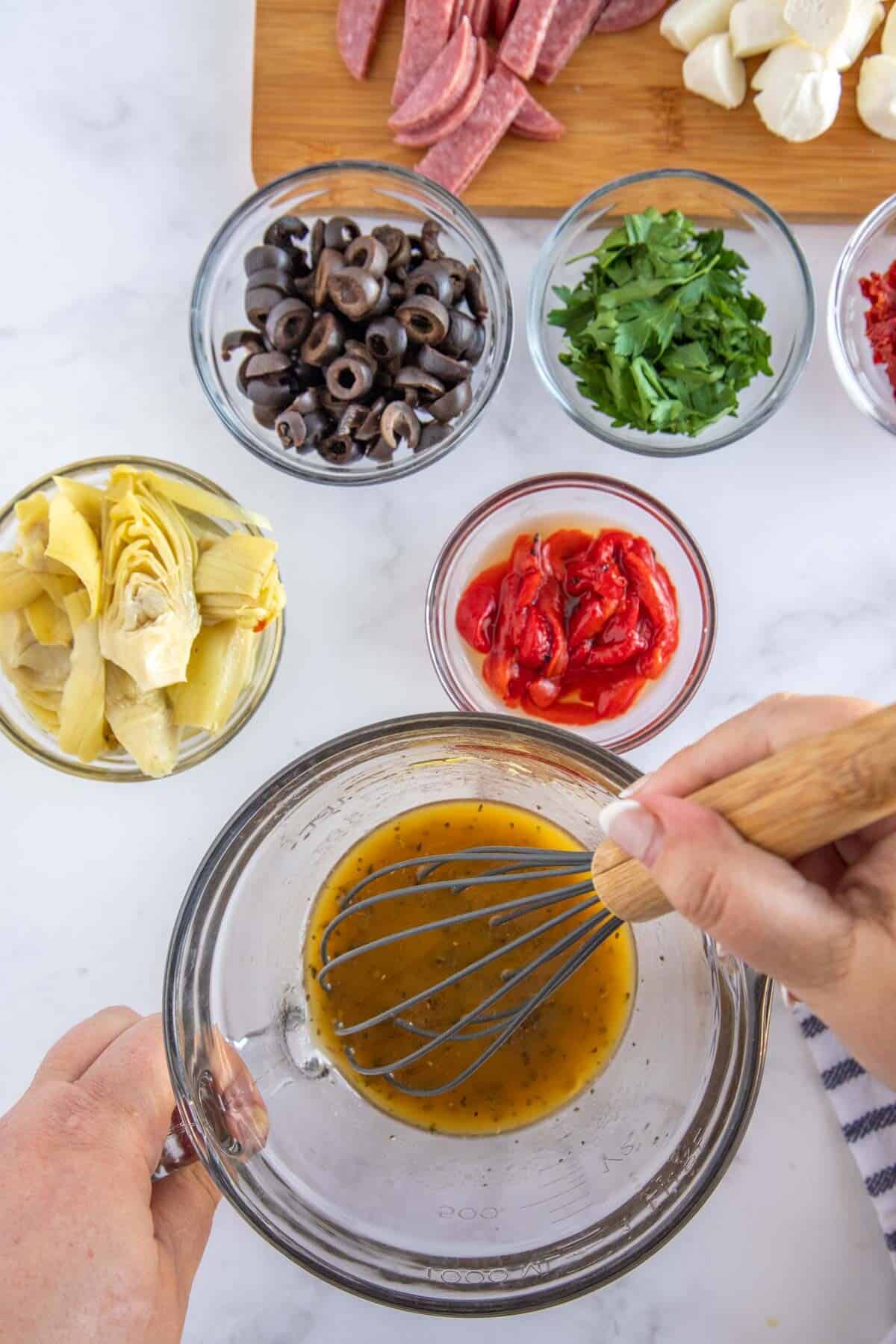 whisking an italian dressing together.