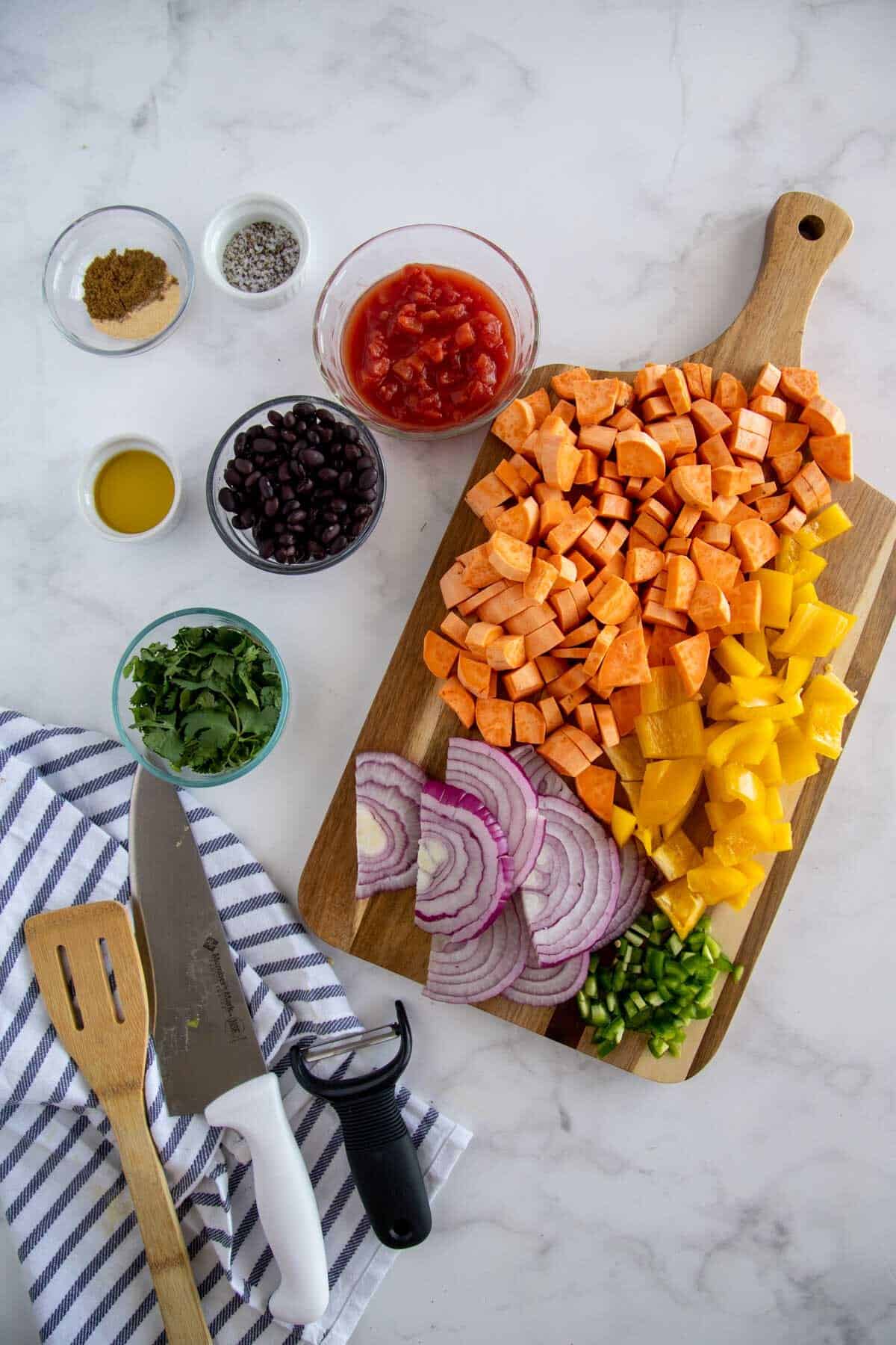 cut vegetables on a wooden chopping board