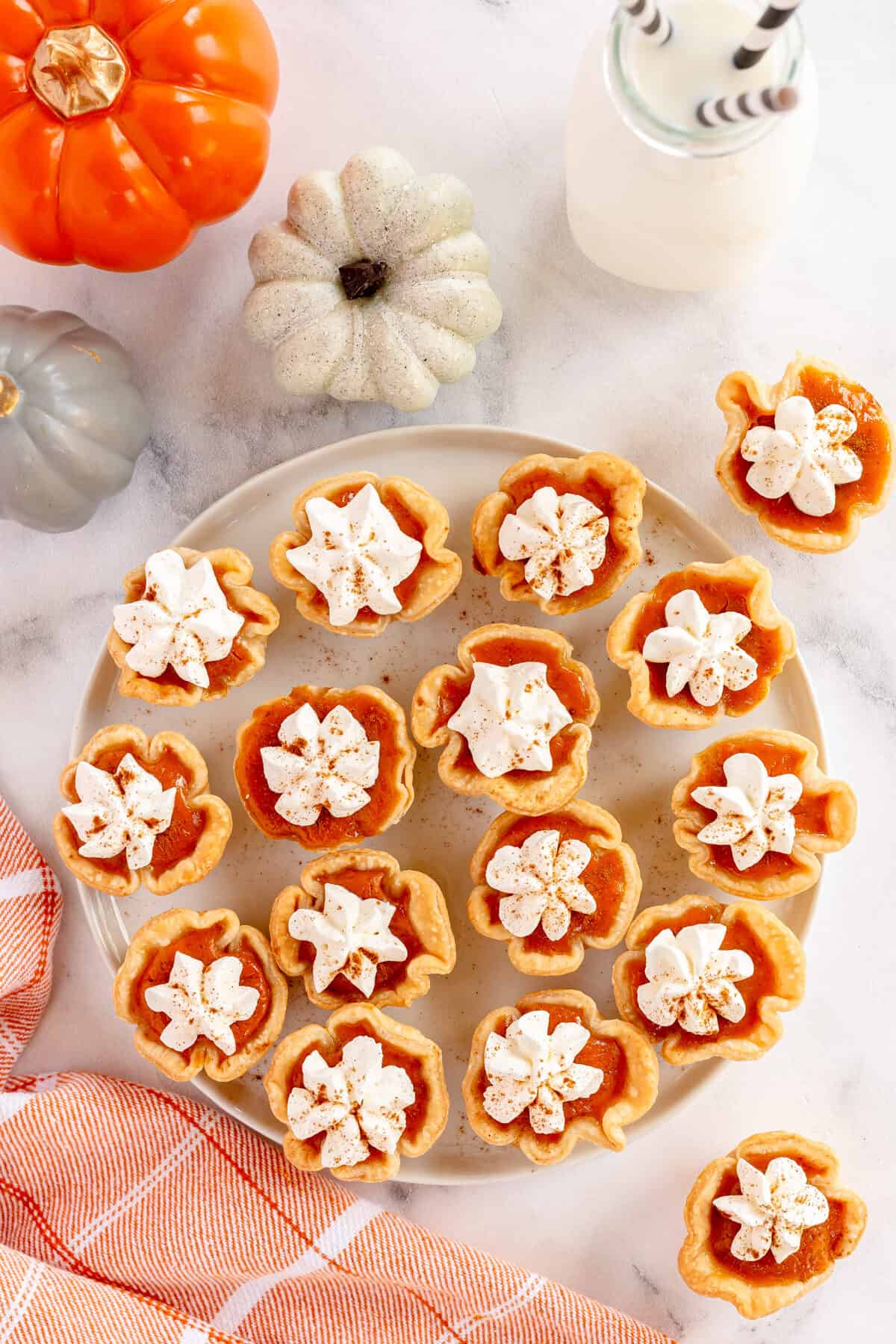 overhead of pumpkin pies on a white plate with a napkin