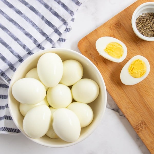 boiled eggs in a bowl with one cut open