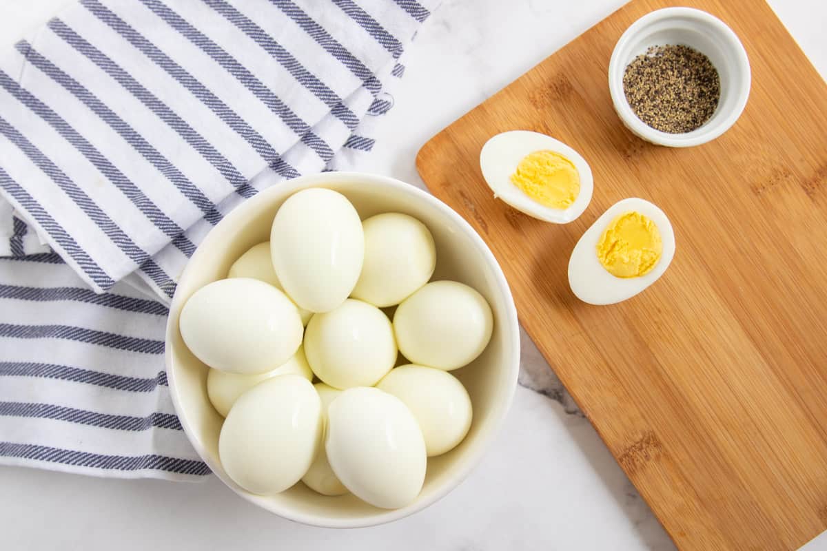 boiled eggs in a bowl with one cut open
