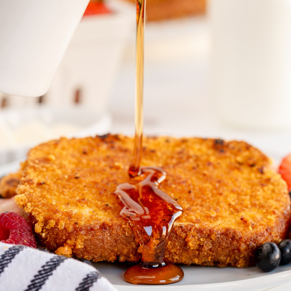 crunchy french toast with syrup being poured over