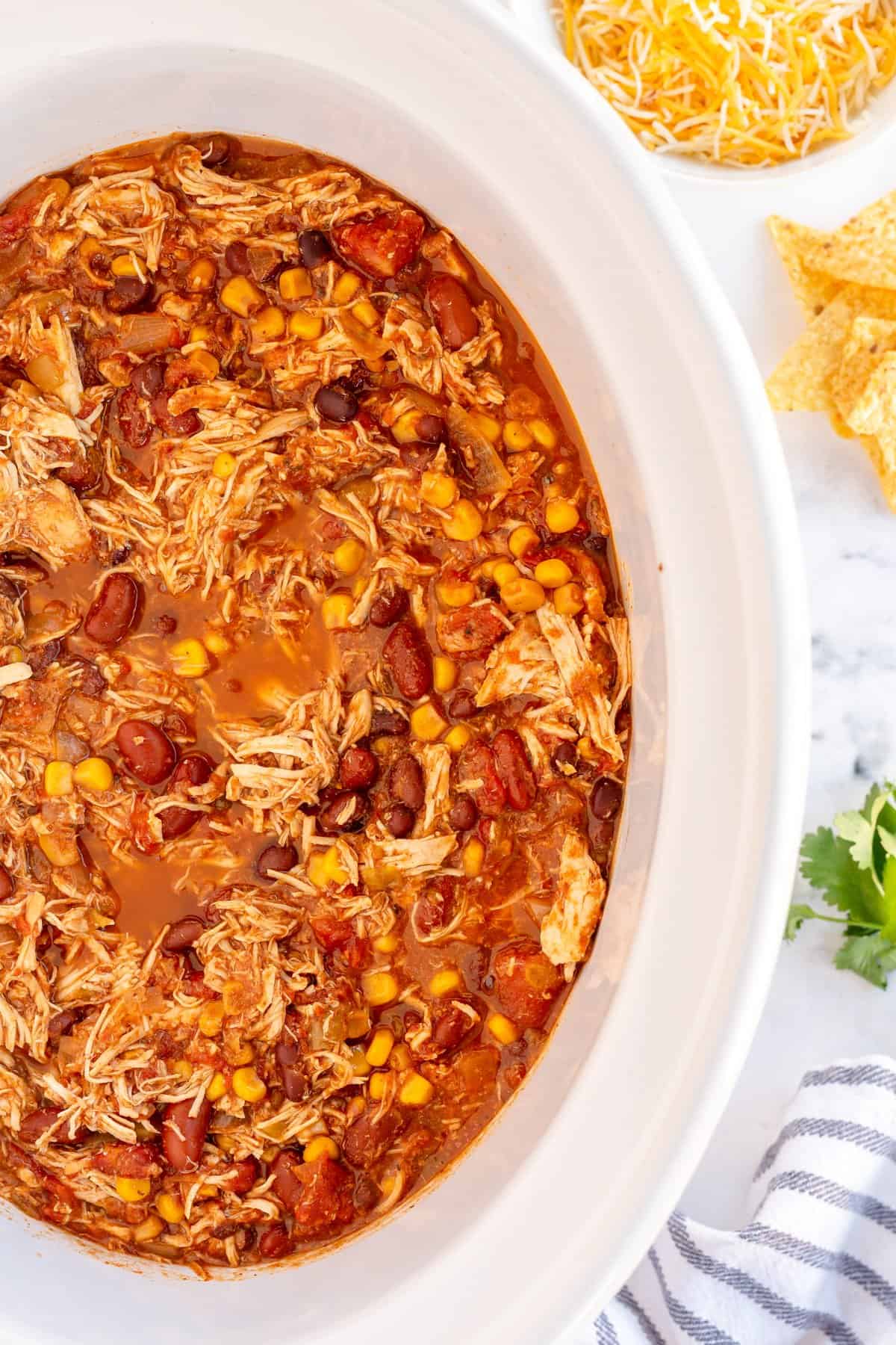 cooked chicken chili in a white slow cooker