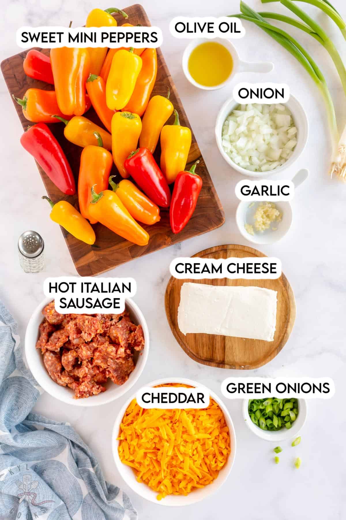 Ingredients to make stuffed mini peppers laid out and labeled