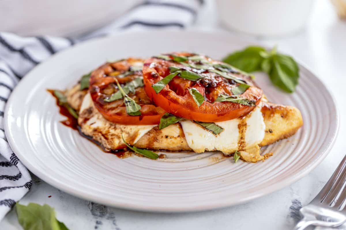 chicken caprese served on a white plate