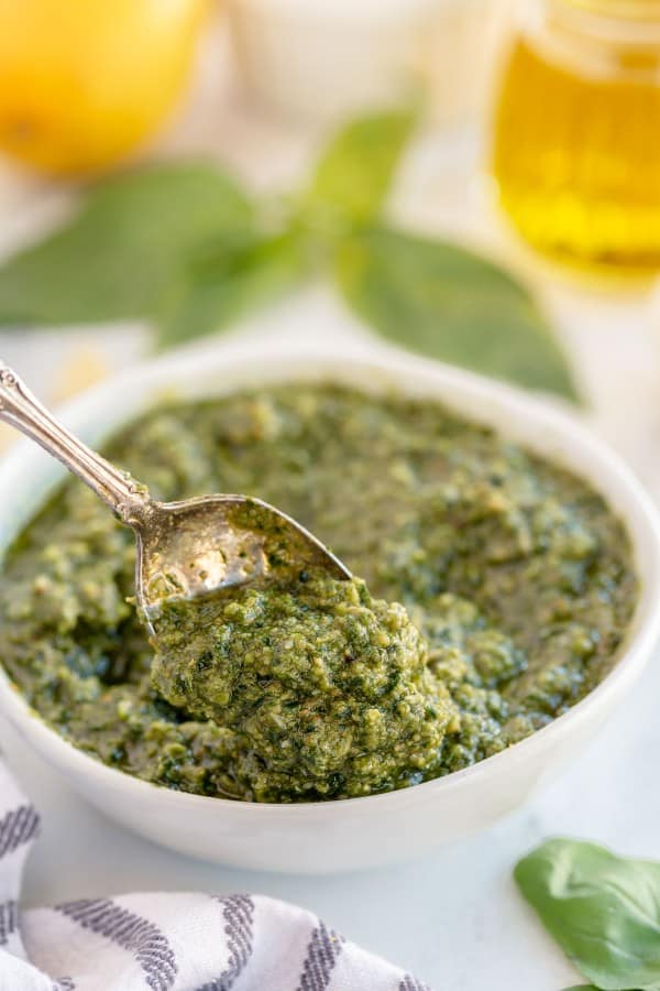 pesto in a white bowl with a spoon
