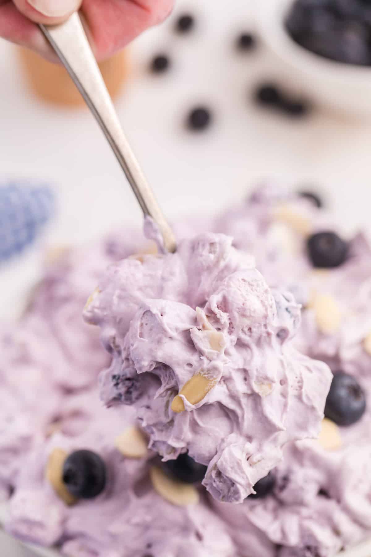 close up spoonful of blueberry fluff salad.