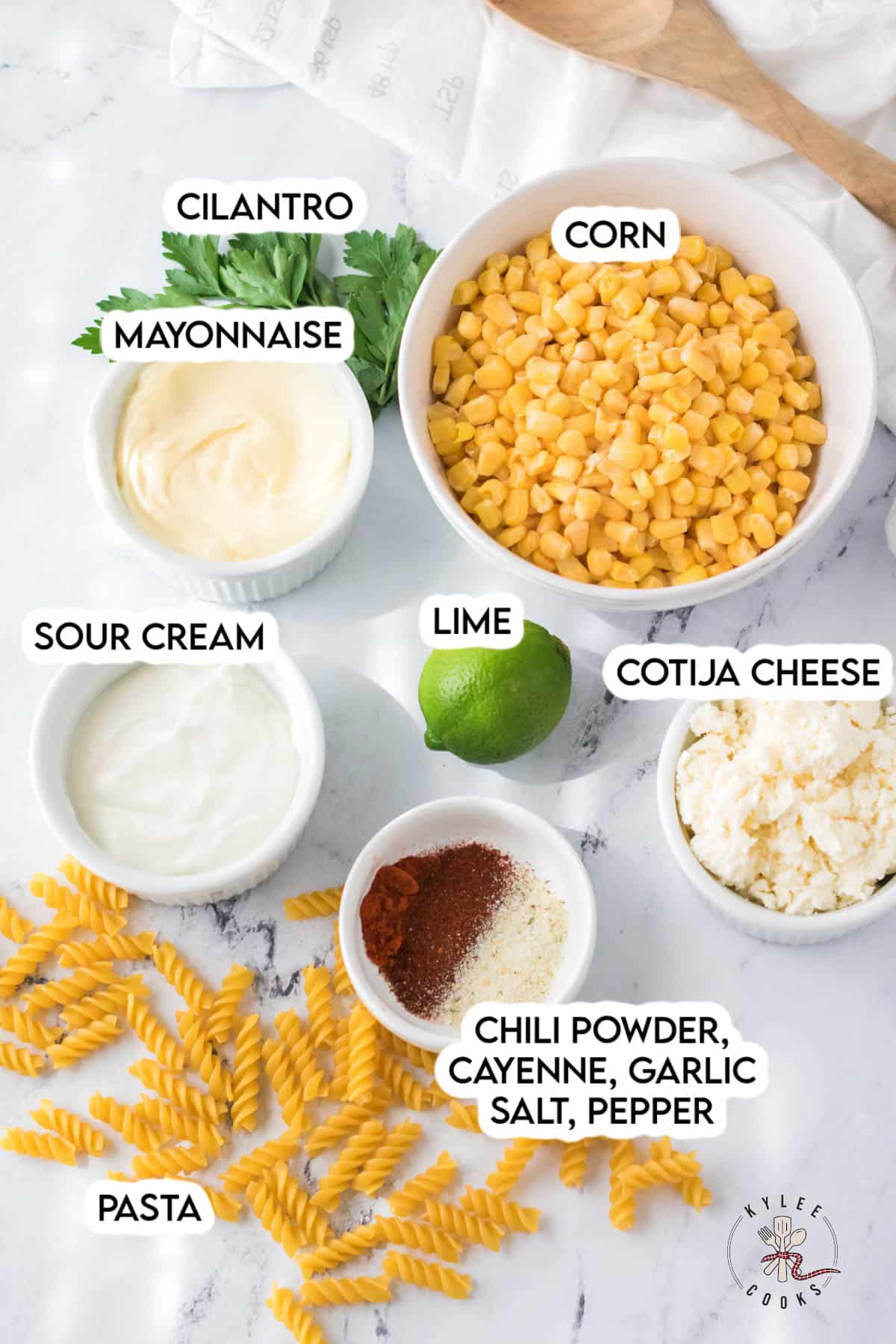 ingredients to make street corn pasta salad laid out and labeled