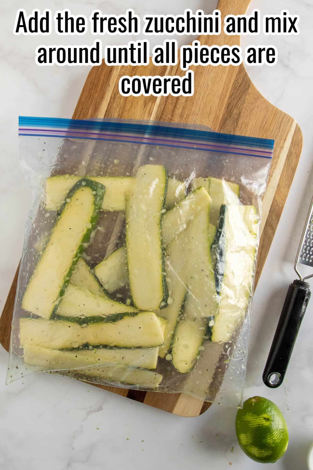 Zucchini slices in a freezer bag, marinating.