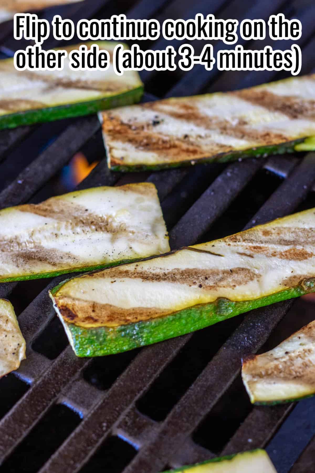 Zucchini slices on a grill, with grill marks.